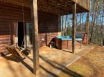 Hot Tub on lower level porch right off the bedroom with a porch swing 